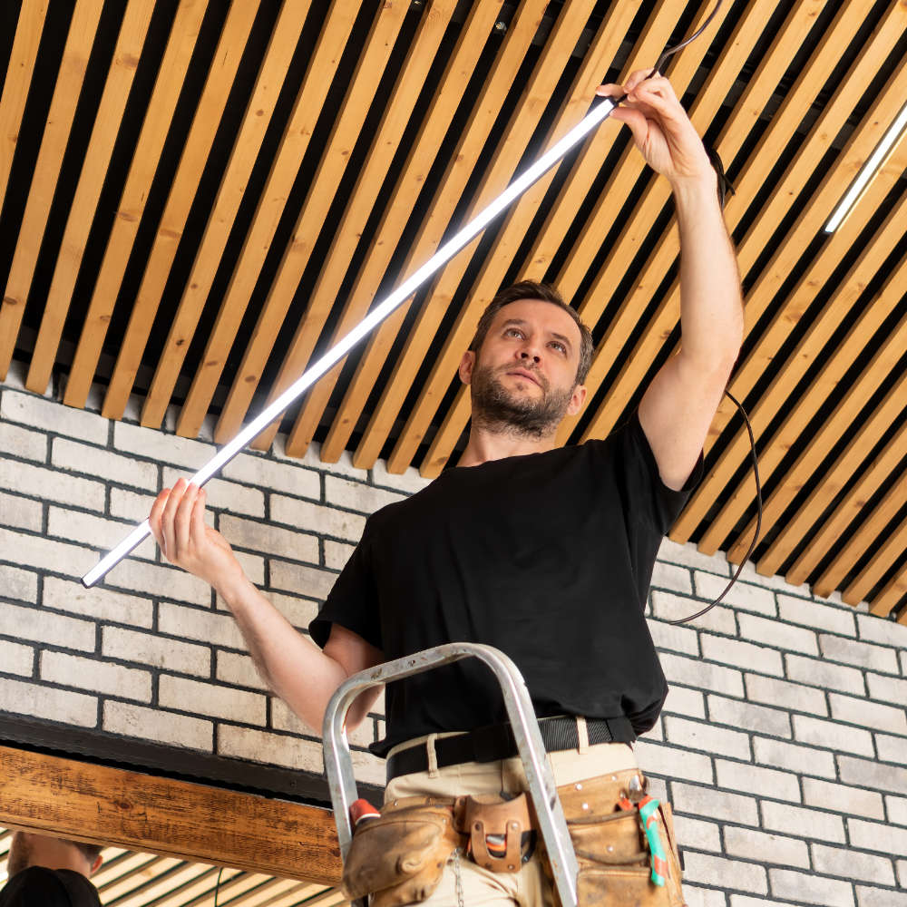 Man installing lighting in ceiling
